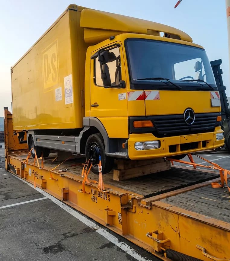 Mercedes commercial truck on flatrack for export